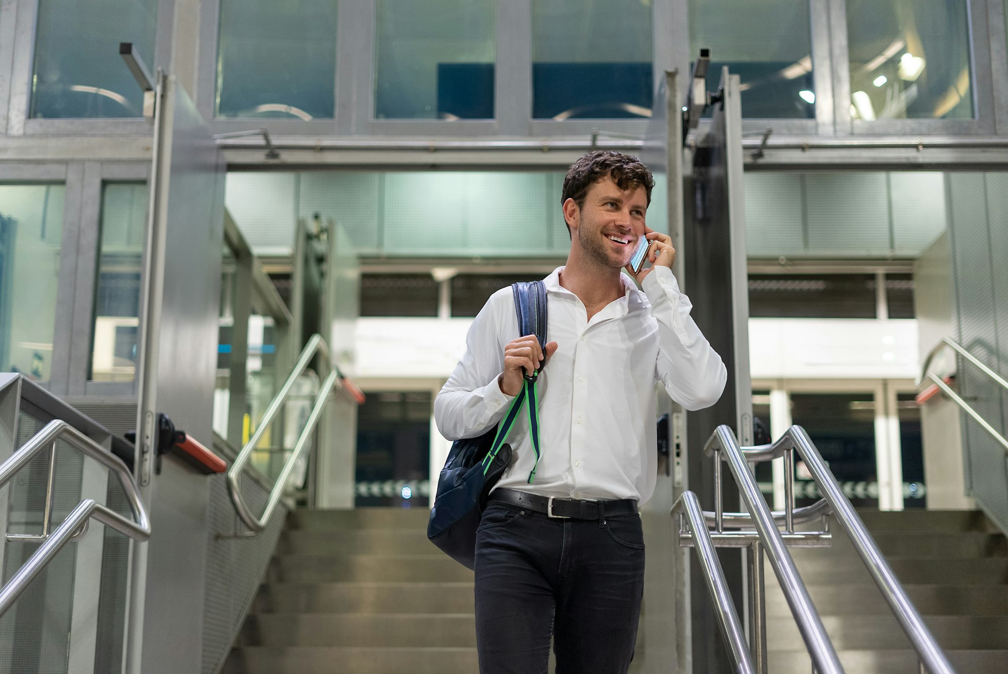 Businessman speaking on smartphone in airport